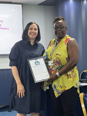 Councillor Ali presenting Silver award to Dog Kennel Hill Primary School